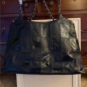 Vintage black patchwork leather giant tote bag w silver hardware.